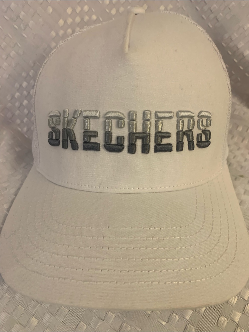 White Sketchers One Size snap back cap with mesh back.